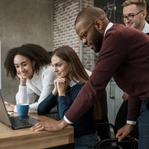 woman-showing-something-her-colleagues-during-meeting